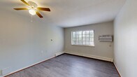 Located at 2021 Blaine St in Detroit, Michigan, this one-bedroom, one-bathroom unit offers a practical and efficient layout across a single floor. The combined living and dining area serves as the heart of the space, featuring durable laminate wood flooring, a ceiling fan, baseboard heating, and a wall-mounted air conditioning unit. A large window allows natural light to fill the room and provides views of the surrounding greenery. The galley-style kitchen is positioned adjacent to the living area, separated by a half-wall with a pass-through counter. It includes cream-toned cabinetry on both sides, ample counter space, a stainless steel sink, a white electric range, and a full-size refrigerator — all complemented by hard surface flooring for easy maintenance. The bedroom is carpeted for comfort and features a large built-in closet with bi-fold wooden doors, along with an additional closet for extra storage. A window brings in natural light and provides a pleasant outdoor view. The bathroom is clean and functional, featuring a tiled shower/tub combination and wood-style flooring. A dedicated entrance area and hallway connect all rooms efficiently, with multiple closets throughout adding to the unit's overall storage capacity.