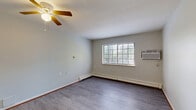 Located at 2021 Blaine St in Detroit, Michigan, this one-bedroom, one-bathroom unit offers a practical and efficient layout across a single floor. The combined living and dining area serves as the heart of the space, featuring durable laminate wood flooring, a ceiling fan, baseboard heating, and a wall-mounted air conditioning unit. A large window allows natural light to fill the room and provides views of the surrounding greenery. The galley-style kitchen is positioned adjacent to the living area, separated by a half-wall with a pass-through counter. It includes cream-toned cabinetry on both sides, ample counter space, a stainless steel sink, a white electric range, and a full-size refrigerator — all complemented by hard surface flooring for easy maintenance. The bedroom is carpeted for comfort and features a large built-in closet with bi-fold wooden doors, along with an additional closet for extra storage. A window brings in natural light and provides a pleasant outdoor view. The bathroom is clean and functional, featuring a tiled shower/tub combination and wood-style flooring. A dedicated entrance area and hallway connect all rooms efficiently, with multiple closets throughout adding to the unit's overall storage capacity.