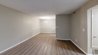 Located at 801 Chinquapin Rd in Columbia, SC, this single-floor, three-bedroom, three-bathroom home offers a functional and efficiently organized layout. The open living area features wood-look laminate flooring and a textured ceiling, with a wide window that draws in natural light and provides views of the surrounding greenery. A chandelier overhead adds a touch of warmth to the dining area, which flows seamlessly into the kitchen.

The kitchen is well-appointed with white cabinetry, marble-look countertops, a double stainless steel sink, and white appliances including a refrigerator and range. The galley-style design maximizes storage and workspace efficiently.

Each of the three bedrooms is finished with neutral-toned carpet and taupe walls, contributing to a calm and consistent aesthetic throughout. The primary bedroom offers a comfortable footprint with a window allowing natural light. The remaining bedrooms share a similar design, featuring textured ceilings and ample wall space.

All three bathrooms are consistently finished with white tile surrounds on the tub-shower combinations and chrome fixtures, providing a clean and straightforward utility. A connecting hallway ties the layout together, ensuring smooth flow between all areas of the home.