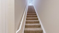 This 720 square foot apartment in Bargersville, IN, offers a thoughtful layout maximizing space and functionality. The open-concept design seamlessly integrates the kitchen, living, and dining areas, creating a spacious feel. The modern kitchen boasts wooden cabinets, granite countertops, and black appliances, including a refrigerator, stove, and built-in microwave.

The living area is bright and airy, featuring light hardwood flooring and large French doors leading to a balcony, allowing natural light to flood the space. A ceiling fan adds both style and comfort. The bedroom, measuring 150 square feet, includes plush carpeting and two windows with blinds for privacy and light control. It also features ample closet space with built-in shelving.

The bathroom is efficiently designed with a single vanity, toilet, and what appears to be a shower/tub combination. Throughout the apartment, neutral paint colors create a fresh, clean ambiance. The property's single floor layout enhances accessibility and ease of movement. Overall, this apartment combines modern amenities with a practical design, ideal for comfortable, contemporary living.