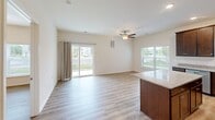 This 2-bedroom, 2-bathroom unit at 110 Bulmer Loop in Winchester, VA offers a well-designed, single-floor layout with a clean, modern aesthetic throughout. Light vinyl plank flooring runs seamlessly across all living areas, complementing the neutral, light-toned walls and crisp white trim that define the interior.

The open living area is bright and airy, benefiting from large windows and a sliding glass door that provides outdoor access and fills the space with natural light. A ceiling fan overhead adds comfort and functionality. The kitchen is appointed with dark wood cabinetry, a central island with granite countertops, and stainless steel appliances, offering both style and practicality.

The spacious primary bedroom features a ceiling fan, generous windows with outdoor views, and ample room for furnishings. The second bedroom is comparably well-sized, also featuring a window that brings in natural light. A dedicated closet provides additional storage within the unit.

Both bathrooms are finished with warm wood-toned vanities and light countertops. One bathroom includes a walk-in shower with a chrome fixture, while the other is equipped with accessibility features including a grab bar. The overall layout is efficient, functional, and move-in ready, making this Winchester unit a comfortable and practical living space.
