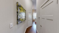 Located at 805 Canal St in Chattanooga, TN, this one-bedroom, one-bathroom residence offers a thoughtfully designed single-floor layout that maximizes every square foot. The kitchen is a standout feature, showcasing rich dark wood cabinetry extending nearly to the ceiling, granite-style countertops, a full suite of stainless steel appliances including a refrigerator, dishwasher, microwave, and electric range, and a central island with a dark countertop and bar seating — ideal for casual dining or meal prep. Warm hardwood flooring flows throughout the main living areas, complementing the neutral wall tones and creating an inviting atmosphere. The bedroom features impressively tall ceilings that lend a sense of openness well beyond its footprint, with soft carpeting and a clerestory-style window allowing in natural light. The bathroom offers a classic aesthetic with white subway tile surrounding a full soaking tub and shower combination, brushed gold fixtures, and light wood-tone flooring. Throughout the space, high ceilings and a clean, modern-meets-classic design sensibility create an atmosphere that feels airy and functional, making this a well-appointed urban residence in the heart of Chattanooga.