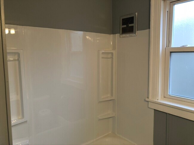 New tub surround, faucets, drain, shower head, and glazed tub - 633 Elgin Ave