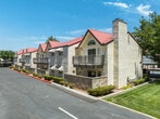 Located in Lancaster, CA, Unit #206 at 43100 30th St W is a thoughtfully designed single-floor residence that blends comfort and modern updates throughout. The living room serves as the heart of the home, boasting soaring vaulted ceilings with an arched upper window that fills the space with abundant natural light. A tiled fireplace adds a warm focal point, while sliding glass doors open to an outdoor balcony, extending the living area. Plush carpeting runs throughout the living and bedroom areas, adding warmth underfoot.

The kitchen has been attractively updated with crisp white shaker cabinetry, granite-look countertops, stainless steel appliances including a gas range, microwave, and refrigerator, and easy-care wood-look flooring. A pass-through view connects the kitchen to the main living space.

The entry hallway provides practical closet storage and leads to the bedrooms, each of which features soft carpeting, generous natural light from windows overlooking the surrounding community, and ample wall space. Both bathrooms are well-appointed with tub/shower combinations, granite-topped vanities, and wood-look tile flooring. A ceiling fan in the secondary living area adds comfort. The textured ceilings are consistent throughout, giving the home a cohesive character.