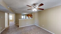 Located at 296 Muellers Cir in Statesville, NC, this single-floor, 2-bedroom, 2-bathroom home offers a practical and comfortable layout. The combined kitchen and living area forms the heart of the home, with the kitchen featuring warm oak cabinetry, ample storage, white appliances including a refrigerator and range, and easy-to-maintain tile flooring. A textured ceiling and flush-mount lighting complete the functional space.

Both bedrooms are carpeted and bathed in natural light from windows overlooking the outdoors. Ceiling fans with light kits are installed in each bedroom, enhancing comfort year-round. The primary bedroom is a well-proportioned retreat with a closet for storage, while the second bedroom also offers a double-door closet. Neutral, warm-toned walls carry throughout the home, creating a cohesive and inviting atmosphere.

The two bathrooms are finished in clean, white fixtures. One features a full soaking tub and shower combo, while the other offers a standalone walk-in shower — both with tile flooring and chrome accents. An additional utility or flex room with tile flooring provides versatility. White trim and textured ceilings are consistent throughout, giving the home a tidy, uniform appearance.