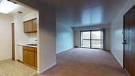 This Classic two-bedroom, two-bathroom unit features a practical single-floor layout designed to maximize functionality. The living room is generously sized, with wall-to-wall carpeting and a large sliding glass door that opens to a private balcony, filling the space with natural light and providing outdoor views. An entry foyer leads into the open living area, which connects seamlessly to the kitchen via a pass-through window, enhancing the sense of openness.

The galley-style kitchen is efficiently organized with warm wood cabinetry lining both sides, light countertops, tile flooring, and white appliances including a refrigerator, range, and dishwasher. Ample upper and lower cabinet storage makes the space highly practical.

Both bedrooms are carpeted and well-proportioned, each featuring windows that bring in natural light and outdoor views. Closets with sliding wood doors provide solid storage. One bedroom offers convenient access to an in-unit laundry area.

The two bathrooms are cleanly finished. One features a full tub-shower combination with white tile surround, while the other includes an extended vanity with a wide mirror, wood cabinetry, and tile flooring, providing a functional and organized space.