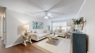 Located at 1600 Governors Dr in Pensacola, Florida, this well-appointed 2-bedroom, 3-bathroom single-story home offers a comfortable and functional layout designed for everyday living. The inviting living room serves as the heart of the home, featuring rich hardwood-style flooring, crown molding, a textured ceiling, and a ceiling fan that enhances airflow and comfort. Large windows allow natural light to fill the space, creating a bright and welcoming atmosphere. The kitchen is equipped with warm oak cabinetry, laminate countertops, a full suite of appliances including a dishwasher, electric range, and built-in microwave, along with a sink and ample counter space for meal preparation. The spacious primary bedroom offers plush carpet flooring and a ceiling fan, complemented by a generously sized walk-in closet with wire shelving for organized storage. The secondary bedroom also features carpet flooring, a ceiling fan, and natural light from a window. Three bathrooms provide convenience and privacy, each featuring tub-shower combinations, vanities with oak cabinetry, and tile flooring. Two dedicated closets throughout the home offer additional storage. The overall ambiance is clean, light, and functional, making this Pensacola home a practical and comfortable retreat.