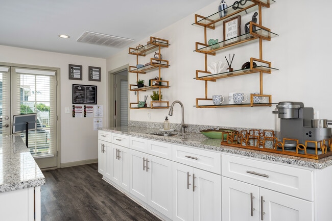 Enjoy updated kitchens with bright white cabinets and luxurious marble countertops, professionally operated by Highlands Vista Group. - Arbours at Victoria Place
