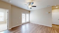 Located at 311 Hope Bird Lane in Longs, SC, this well-designed two-bedroom, two-bathroom home offers a comfortable and functional single-floor layout. The living area features warm hardwood-style flooring, neutral beige walls, and a ceiling fan with light fixture, creating a bright and airy atmosphere. French doors lead to an outdoor view, filling the space with natural light. The kitchen is a standout, equipped with white shaker cabinetry, granite countertops, stainless steel appliances, a kitchen island with pendant lighting, and a sink—ideal for both everyday cooking and entertaining. A dedicated laundry room houses a full-size top-loading washer and dryer with overhead wire shelving for added storage. The primary bedroom is a comfortable retreat with plush carpet, a ceiling fan, large windows offering outdoor views, and a walk-in closet. The second bedroom also features carpet flooring and clean neutral tones. Both bathrooms are finished with white shaker vanities, granite countertops, large mirrors, and hardwood-style flooring; one includes a tub-shower combination. A well-organized hallway with multiple closets adds practical storage throughout. The home's cohesive, modern finishes and thoughtful layout make it a move-in-ready residence.