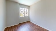 Located at 11950 Idaho Ave in the desirable West Los Angeles neighborhood of 90025, this single-floor residence offers a well-designed layout with a clean, contemporary aesthetic throughout. Rich wood-style flooring flows through the main living areas, creating a warm and cohesive atmosphere, while tile flooring is featured in the kitchen and bathrooms.

The open living area is bright and inviting, benefiting from natural light that pours in through sliding glass doors leading to a private balcony with views of the surrounding neighborhood and lush palm trees. The kitchen is thoughtfully appointed with warm wood cabinetry, stainless steel appliances including a gas range, microwave, and refrigerator, complemented by a mosaic tile backsplash and a light stone countertop peninsula that opens to the main living space. A tasteful chandelier adds a refined touch to the dining area.

The bedrooms are generously sized, each featuring wood-style flooring and windows that welcome natural light and outdoor views. Arched doorway details lend architectural character to the space. The bathroom is elegantly finished with a vessel sink, wide vanity mirror, stone countertops, and a glass-enclosed shower, with natural light provided by frosted windows. The overall ambiance is bright, modern, and move-in ready.