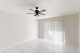 Located at 10101 W Sam Houston Parkway in Houston, TX, this well-designed one-bedroom, one-bathroom residence offers a practical and comfortable single-floor layout. Gleaming large-format tile flooring runs throughout the entire unit, lending a clean, cohesive aesthetic to every room.

The open-concept living, dining, and kitchen area forms the heart of the home. The kitchen is outfitted with white cabinetry, a granite-look countertop with a peninsula breakfast bar, black appliances including a range and refrigerator, a built-in sink, and a pantry for additional storage. The living area benefits from a ceiling fan with light fixture and a sliding glass door dressed with vertical blinds, allowing natural light to fill the space.

The bedroom is a well-proportioned retreat, featuring a ceiling fan, a window with blinds for natural light, and direct access to a walk-in closet with built-in shelving. A second closet provides even more storage. The full bathroom is conveniently accessible from the bedroom. A dedicated laundry area is also included within the unit. The entry foyer is welcoming, featuring a distinctive blue front door and a large window with horizontal blinds. This unit offers a thoughtfully organized layout ideal for comfortable everyday living.