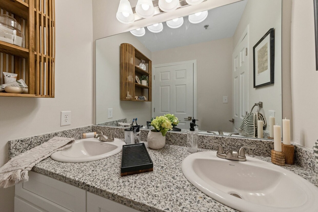 Elegant Bathroom with Double Vanity and Granite Counters - Theater Street Apartments