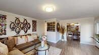 Located in Harvey, Louisiana, this single-story 2-bedroom, 2-bathroom residence offers a functional and stylish layout across a comfortable footprint. The living room serves as the heart of the home, featuring wood-look flooring, crown molding, and a sliding glass door that invites natural light and outdoor views. The adjacent dining area is defined by a pendant chandelier and flows seamlessly into the kitchen, which is equipped with rich dark wood cabinetry, granite-style countertops, a tile backsplash, a kitchen island, and black appliances. The primary bedroom features plush carpeting, multiple windows, and a serene, restful ambiance. The second bedroom also offers carpeted flooring and access to a walk-in closet, making it a versatile and practical space. Both bathrooms are efficiently designed, with one featuring a shower-tub combination. Two hallways connect the rooms, contributing to a logical and easy-to-navigate floor plan. Throughout the home, wood-look flooring in the common areas and soft carpet in the bedrooms provide a cohesive yet comfortable aesthetic, making this residence a well-balanced blend of function and warmth.