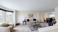 This well-appointed two-story home in Novi, Michigan offers four bedrooms, two bathrooms, and a thoughtfully designed layout spread across two floors. The main living area features a bright, open-concept living and dining room combination finished with plush wall-to-wall carpeting and neutral tones that create a warm, welcoming ambiance. Large windows invite generous natural light, with views of the surrounding neighborhood greenery. The living room provides a comfortable gathering space, while the adjacent dining area is highlighted by a pendant light fixture overhead, seamlessly connecting to the kitchen. The spacious primary bedroom features large windows with neighborhood views and soft carpeting, offering a peaceful retreat. Additional bedrooms are well-sized and bright, including a charming room with cheerful decor and ample closet space. One bedroom showcases a distinctive bay window arrangement, filling the room with natural light and providing a cozy reading nook. The bathrooms are cleanly finished, with one featuring a glass-enclosed walk-in shower and tile flooring. A utility room and two hallways complete the functional floor plan. The home's consistent use of neutral walls, soft carpeting, and classic finishes throughout creates a cohesive and comfortable living environment.