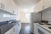 Located at 55 McMurchy Ave N in Brampton, Ontario, this 2-bedroom, 1-bathroom unit offers a practical and well-designed layout across a single floor. The galley-style kitchen is efficiently organized with white cabinetry, dark countertops, a stainless steel sink, and white appliances including a refrigerator and electric range. It flows seamlessly into a combined living and dining area, which is bright and open, featuring light-toned laminate flooring and warm neutral walls that create a clean, welcoming atmosphere. Both bedrooms are comfortably sized, each featuring the same laminate flooring, neutral walls, and sliding windows that bring in natural light and views of the surrounding neighbourhood. Baseboard heaters are present in each bedroom. The bathroom is finished with white tile surrounding a full soaker tub and shower combination, maintaining a crisp, clean aesthetic. A standout feature of this unit is the private balcony, accessible from the living area, which offers open views of the Brampton cityscape, mature trees, and neighbouring buildings under an expansive sky. The unit's consistent flooring, neutral palette, and functional layout make it a practical and comfortable urban residence.