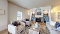 Located in Sherwood, Oregon, this thoughtfully designed multi-level home offers 2 bedrooms, 3 bathrooms, and a dedicated office spread across three floors. The main living level is the heart of the home, where an open-concept layout connects the living room, dining area, and kitchen. The living room features durable hardwood-style flooring, a tile-surround fireplace with an elegant arched built-in above, and large windows that invite abundant natural light. The dining area opens directly to a private deck through sliding glass doors, offering pleasant outdoor views. The kitchen is well-appointed with warm wood cabinetry, granite countertops, stainless steel appliances including a gas range and refrigerator, and a breakfast bar. All three bathrooms feature granite countertops and warm wood vanities with undermount sinks. The upper level houses the bedrooms, including a generously sized primary bedroom with vaulted ceilings and plush carpeting. The second bedroom is equally comfortable with high ceilings and soft carpet. The office benefits from vaulted ceilings and a bright window, creating an ideal work-from-home environment. The entry level provides a welcoming transition into this well-appointed Sherwood residence.