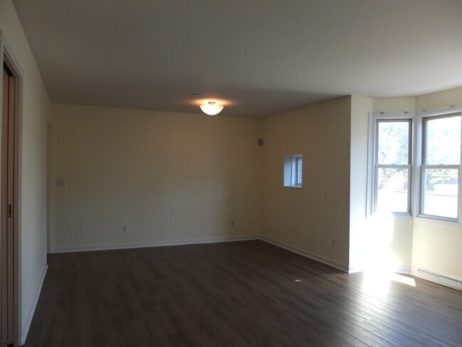 Combination living and dining area with newer flooring - 95 Audubon St