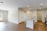 Located at 7105 Hall Rd in Union City, GA, this well-designed single-story home offers three bedrooms and two bathrooms within a thoughtfully laid-out floor plan. The open-concept living area is a standout feature, seamlessly connecting the kitchen, dining, and living spaces. The kitchen is anchored by a central island with a granite countertop, an undermount sink, recessed lighting, and stainless steel appliances, including a refrigerator. A dedicated pantry provides additional storage. The living room is bright and airy, featuring wood-style flooring and French doors that invite natural light and offer outdoor views. Each bedroom is generously proportioned, with large windows that frame views of the surrounding greenery and continue the warm wood-style flooring found throughout the home. The spacious primary bedroom includes a walk-in closet with wire shelving systems for ample storage. Both bathrooms are clean and functional, each featuring a tub-shower combination with built-in shelving and granite-topped vanities. Additional conveniences include a dedicated laundry room, a hallway connecting the private spaces, and a total of four closets ensuring abundant storage throughout the home.