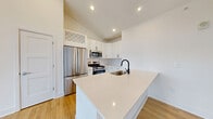 This 700 square foot, single-floor apartment offers a contemporary living space with a thoughtful layout. The open-concept design seamlessly integrates the kitchen, living, and dining areas, creating a spacious feel within the compact footprint. The kitchen boasts modern white cabinetry, stainless steel appliances, and a stylish black faucet, complemented by a subway tile backsplash.

The 150 square foot bedroom provides ample space and features a large window, allowing natural light to flood the room. The bathroom continues the modern aesthetic with a white vanity, backlit mirror, and a combination of wood-look flooring and white tiles. A walk-in closet offers generous storage space with adjustable shelving.

Throughout the apartment, warm wood-look flooring contrasts beautifully with the crisp white walls, creating a bright and inviting atmosphere. Large windows in the living area and bedroom offer picturesque views and abundant natural light. The living room opens to a balcony through glass doors, extending the living space outdoors.

Attention to detail is evident in the recessed lighting, modern ceiling fan, and sleek window treatments. This well-designed apartment efficiently utilizes its 700 square feet to provide a comfortable and stylish living environment in Merrillville, Indiana.