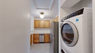 Located at 1437 Lucile Ave SW in Atlanta, GA, this 2-bedroom, 1-bathroom unit offers a well-organized single-floor layout that maximizes every inch of its compact footprint. Warm hardwood flooring flows throughout the living areas and bedrooms, lending a cohesive and inviting feel to the entire space.

The combined kitchen and living room serves as the heart of the home. The kitchen is outfitted with light natural wood cabinetry, white quartz-style countertops, a classic white subway tile backsplash, and stainless steel appliances including a refrigerator, range, microwave, and dishwasher. A distinctive black-and-white mosaic tile floor adds a charming retro touch. A peninsula with a sink provides additional prep space and casual seating potential.

The living area is bright and airy, with a front-facing window that draws in natural light and direct access to the entry door. Both bedrooms continue the hardwood flooring and feature ceiling fans with light fixtures. The primary bedroom is generously sized, offering a double-door closet and additional storage. The second bedroom also benefits from natural light through a window with an outdoor view.

The bathroom features classic cream wall tile, a shower-tub combo with dark hardware, and a black-and-white mosaic floor. A dedicated laundry area and connecting hallway complete this functional and thoughtfully laid-out home.