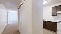 Located at 7549 E Culver St in Scottsdale, Arizona, this single-floor residence offers three bedrooms, one bathroom, a hallway, and a closet within a compact and efficiently arranged floor plan. The interior is finished with warm, neutral-toned carpet throughout the living areas and bedrooms, creating a cohesive and understated aesthetic. White walls and textured ceilings are consistent across the space, lending a clean, straightforward look.

The spacious primary bedroom is notably generous in size, featuring a sliding glass door dressed with vertical blinds that opens to an outdoor area with views of the surrounding neighborhood, allowing natural light to fill the room. A second bedroom includes a window with a horizontal blind, offering additional natural light, while a third, more compact bedroom provides a flexible space for various uses.

The living area connects to a kitchen via a pass-through counter with a built-in stovetop and cabinetry finished in dark espresso tones, complemented by a light granite-style countertop. Sliding closet doors with a mirrored finish are found near the hallway, maximizing storage efficiency.

The bathroom features a combined tub and shower, a toilet, and a separate vanity area with a granite-topped counter, dual mirrors, and medicine cabinets, offering practical functionality. The overall layout is straightforward and well-suited for comfortable single-floor living in the Scottsdale area.