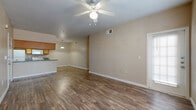 Located at 535 Gembler Road in San Antonio, Texas, this single-floor residence offers a practical and well-organized layout across two bedrooms, a living room, dining room, kitchen, and a private patio. The living area features warm beige walls, plush carpeting, and a ceiling fan, creating a comfortable and inviting atmosphere. Wood-look hard flooring extends through the kitchen and dining areas, providing a clean contrast to the carpeted spaces. The kitchen is efficiently designed with warm oak cabinetry, dark countertops, a double-basin sink, and white appliances including a refrigerator, range, dishwasher, and microwave. A breakfast bar connects the kitchen to the adjacent dining area, enhancing the open feel of the space. The primary bedroom offers a ceiling fan, closet access, and a window that brings in natural light, while the second bedroom similarly features carpet flooring, a ceiling fan, and a bright window with exterior views. Both bedrooms include dedicated closet spaces. The unit also includes a patio, providing an outdoor retreat. With a neutral color palette throughout and consistent finishes, this residence delivers a clean, functional living environment suited for everyday comfort.