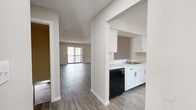 Located on Alan Drive in Weatogue, Connecticut, this two-bedroom, two-bathroom two-story home offers a well-organized layout across two levels. The lower level houses a combined kitchen and living area, a utility room, and a staircase connecting to the upper floor. The kitchen features white cabinetry, a stainless sink, a black dishwasher, and stainless steel refrigerator, with wood-look flooring that extends seamlessly into the spacious living area. A sliding glass door floods the living room with natural light and provides outdoor access. The upper level contains both bedrooms, two full bathrooms, a hallway, and three closets. The generously sized primary bedroom includes a walk-in closet with dual hanging rods and shelving. The second bedroom offers plush carpeting, a large window with exterior views, and its own closet. Both bathrooms are finished with white vanities, wood-look flooring, and clean, neutral wall tones. Throughout the home, a consistent palette of warm gray walls and crisp white trim creates a bright, cohesive aesthetic. Textured ceilings, updated fixtures, and ample storage make this a highly functional and move-in ready residence in a quiet Connecticut community.