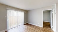 Located at 8791 Hammerly Blvd in Houston, TX, this one-bedroom, one-bathroom unit offers a well-designed single-floor layout with a cohesive, modern aesthetic throughout. Warm wood-look flooring and neutral gray walls create a clean, consistent backdrop across every room.

The open-concept living and kitchen area anchors the unit, with the kitchen featuring white cabinetry accented by gold hardware, granite-look countertops, stainless steel appliances including a range, microwave, dishwasher, and refrigerator, and a galley-style layout that maximizes efficiency. A peninsula with a sink opens toward the living area, enhancing the sense of connectivity. The living room is bright and airy, highlighted by a large sliding glass door with vertical blinds that invites natural light and provides outdoor access.

The bedroom is a comfortable, well-proportioned space with a window overlooking greenery, offering a peaceful retreat. It includes access to a spacious walk-in closet outfitted with wire shelving for organized storage.

The bathroom is finished with a granite-topped vanity, white cabinetry with gold accents, and a full tub-shower combination, maintaining the clean, updated style found throughout the unit.
