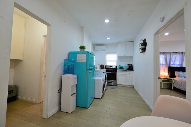 Fully furnished living room with upgraded kitchen, appliances, and laundry machines - 1489 E Colorado Blvd