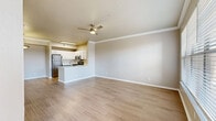 Located at 5382 E 81st St in Tulsa, Oklahoma, this well-designed one-bedroom, one-bathroom residence offers a thoughtful single-floor layout. The open-concept living, dining, and kitchen area serves as the heart of the home, finished with light wood-style flooring, crown molding, and a ceiling fan overhead. Large windows flood the space with natural light, offering pleasant outdoor views. A charming arched architectural detail adds character to the living area.

The kitchen is equipped with stainless steel appliances — including a refrigerator, range, and over-the-range microwave — complemented by white upper cabinetry, gray lower cabinets, and light quartz countertops. A peninsula with a sink provides additional prep space and separates the kitchen from the living area.

The spacious bedroom features plush carpet, a ceiling fan, a generous window with outdoor views, and access to a walk-in closet. Built-in shelving and additional cabinet storage provide practical organization options. Two closets serve the unit in total.

The bathroom includes a full tub-shower combination, a vanity with quartz countertops, white cabinetry, and wood-style tile flooring. A dedicated laundry area adds everyday convenience, rounding out this efficiently designed residence.