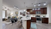 Located at 155 Birdsall St in Houston, TX, this single-floor residence offers a thoughtfully designed open-concept layout that seamlessly connects the kitchen, dining, and living areas. The kitchen is a standout feature, equipped with rich dark-wood cabinetry, a subway tile backsplash, a granite-topped peninsula with an undermount sink, stainless steel appliances, and pendant lighting complemented by track lighting overhead. Wood-look flooring flows throughout the main living areas, enhancing the cohesive aesthetic. The living room is bright and welcoming, with a ceiling fan, access to a private outdoor area through a full-length glass door, and ample wall space for décor. The bedroom offers plush carpeting, a ceiling fan, a mirrored closet, and a calm, neutral palette conducive to rest. The bathroom features large-format tile flooring, a dark-wood vanity with granite countertops, and a well-lit mirror. Completing the unit is a dedicated in-unit laundry area with a full-size stacked washer and dryer. The overall ambiance is modern and comfortable, with consistent finishes throughout that reflect quality and attention to detail.
