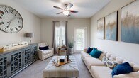 Located at 1035 Alexander Dr in Augusta, GA, this single-floor residence offers 2 bedrooms and 3 bathrooms within a thoughtfully designed layout. The kitchen is a standout feature, showcasing white shaker cabinetry, granite countertops, a subway tile backsplash, and stainless steel appliances including a range, microwave, and sink — all set atop wood-look flooring. The adjacent dining area accommodates a cozy dining set beneath a pendant light fixture, complemented by neutral walls and wood-look flooring. The living room provides a comfortable retreat with carpet flooring and ample space for seating arrangements. The primary bedroom features plush carpeting, a ceiling fan, and access to a walk-in closet with wire shelving for generous storage. The second bedroom similarly offers carpet flooring and a ceiling fan with natural light from a window. Three bathrooms are present, each equipped with tub/shower combinations and granite-topped vanities. A dedicated laundry room houses a full-size washer and dryer alongside wire shelving. Two closets provide additional storage throughout the unit. Neutral tones and consistent finishes throughout create a cohesive and functional living environment.