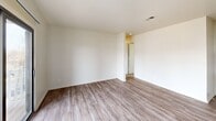 Located at 3006 Hickory Woods Dr in Roanoke, Virginia, this single-floor, two-bedroom, two-bathroom residence offers a comfortable and functional layout across a well-proportioned footprint. The open-concept living and dining area is bright and welcoming, featuring wood-look luxury vinyl plank flooring, a ceiling fan, and a sliding glass door that opens to a private balcony overlooking the surrounding neighborhood. A pass-through counter connects the living area to the galley-style kitchen, which is equipped with warm wood cabinetry, dark countertops, black appliances including a refrigerator, electric range, and dishwasher, and durable LVP flooring. Both bedrooms are generously sized, carpeted for comfort, and filled with natural light from large windows. The primary bedroom offers a dedicated closet for storage. The two bathrooms each feature a full tub-shower combination, wood-vanity with a white countertop, and LVP flooring. A dedicated in-unit laundry room houses a full-size washer and dryer, adding everyday convenience. Two closets throughout the home provide ample storage. The neutral color palette and clean finishes throughout create a bright, move-in-ready atmosphere.