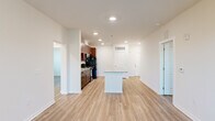 Located at 101 Madison Avenue in Athens, GA, this single-floor, 3-bedroom, 2-bathroom home offers a thoughtfully designed layout with modern finishes throughout. Rich hardwood-style flooring flows consistently across the living spaces, complementing the clean, neutral color palette of the walls and trim.

The kitchen is a standout feature, showcasing deep espresso-toned cabinetry, granite countertops, a subway tile backsplash, and a central island that provides additional prep and dining space. Black appliances, including a refrigerator, range, microwave, and dishwasher, complete the functional setup. Recessed lighting illuminates the kitchen, which opens toward the living area for an easy, connected flow.

The living room benefits from natural light streaming through double doors that lead to a balcony, complemented by a ceiling fan overhead. The spacious primary bedroom features corner windows on two walls, flooding the room with daylight and offering outdoor views. Additional bedrooms are bright and versatile, each with hardwood-style flooring and access to natural light.

Both bathrooms are finished with large-format tile flooring, granite-topped vanities with espresso cabinetry, and tub-shower combinations with white tile surrounds. A dedicated hallway connects all rooms, and a closet provides additional storage. The overall ambiance is clean, modern, and move-in ready.