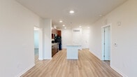 Located at 101 Madison Avenue in Athens, GA, this single-floor, 3-bedroom, 2-bathroom home offers a thoughtfully designed layout with modern finishes throughout. Rich hardwood-style flooring flows consistently across the living spaces, complementing the clean, neutral color palette of the walls and trim.

The kitchen is a standout feature, showcasing deep espresso-toned cabinetry, granite countertops, a subway tile backsplash, and a central island that provides additional prep and dining space. Black appliances, including a refrigerator, range, microwave, and dishwasher, complete the functional setup. Recessed lighting illuminates the kitchen, which opens toward the living area for an easy, connected flow.

The living room benefits from natural light streaming through double doors that lead to a balcony, complemented by a ceiling fan overhead. The spacious primary bedroom features corner windows on two walls, flooding the room with daylight and offering outdoor views. Additional bedrooms are bright and versatile, each with hardwood-style flooring and access to natural light.

Both bathrooms are finished with large-format tile flooring, granite-topped vanities with espresso cabinetry, and tub-shower combinations with white tile surrounds. A dedicated hallway connects all rooms, and a closet provides additional storage. The overall ambiance is clean, modern, and move-in ready.