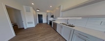 This contemporary 1-bedroom apartment in Bismarck, North Dakota, offers 620 square feet of thoughtfully designed living space. The open-concept floor plan maximizes the use of space, creating a seamless flow between the living areas. The kitchen is a standout feature, boasting sleek white cabinetry, stainless steel appliances, and a subway tile backsplash. It's equipped with a range, microwave, dishwasher, and a spacious refrigerator.

The living area is flooded with natural light thanks to large windows that offer views of the surrounding neighborhood. Wood-look flooring runs throughout the apartment, adding warmth and durability. The bedroom, measuring 140 square feet, provides ample space and includes a closet with built-in shelving.

The bathroom features modern fixtures and a shower/tub combination. A separate laundry area adds convenience to this well-appointed home. Recessed lighting throughout contributes to the bright, airy feel of the space. Located at 2903 Kamrose Drive, this single-story apartment combines style and functionality in a compact, efficient layout.