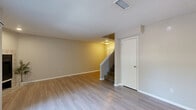 Located at 651 Glades Cir in Altamonte Springs, FL, this two-story, 2-bedroom, 3-bathroom home is thoughtfully laid out across two well-proportioned floors. The main level features an open-concept living room with light wood-look flooring, a textured ceiling, and sliding glass doors that lead to a patio with natural light and outdoor views. The kitchen is well-appointed with white cabinetry, granite-style countertops, a subway tile backsplash, stainless steel appliances including a refrigerator, range, and microwave, and a peninsula with a sink — ideal for both cooking and casual dining. A staircase connects the main floor to the upper level, where the bedrooms are located. The spacious primary bedroom features vaulted ceilings, a ceiling fan, hardwood-style flooring, and a private sliding glass door opening to a balcony overlooking lush greenery. It also includes a walk-in closet. Additional bedrooms are generously sized with their own closet access. The bathrooms are clean and functional, with tiled tub-shower combinations, including a jetted soaking tub in one bathroom. A dedicated laundry area and a storage closet with built-in wire shelving round out the practical amenities of this well-designed home.