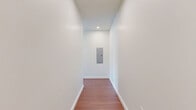 Located at 405 40th Ave N in Nashville, TN, this modern 2-bedroom, 2-bathroom residence offers a thoughtfully designed open-concept layout with high-end finishes throughout. Rich hardwood flooring flows seamlessly across the entire living space, complementing the clean white walls and contemporary aesthetic.

The kitchen and living area form the heart of the home, showcasing a well-appointed kitchen with white upper cabinetry, warm wood-toned lower cabinets, a tile backsplash, and a full suite of stainless steel appliances. A generous island with a white quartz countertop provides additional prep space and casual seating, while pendant lighting and recessed fixtures add layered illumination. Large windows flood the space with natural light and offer open city views of Nashville.

Both bedrooms are well-proportioned with continued hardwood flooring, crisp white walls, and large windows that frame elevated views of the surrounding cityscape. The primary bedroom benefits from its own en-suite bath and a ceiling fan. Each bathroom features a walnut-toned vanity with white quartz countertops, a rectangular under-mount sink, black-framed mirrors, and modern tile flooring — delivering a clean, spa-inspired finish. A hallway and closet complete the functional layout of this refined Nashville residence.