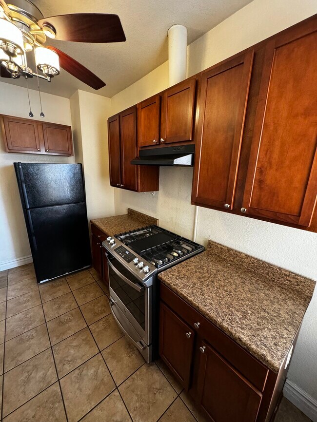 Kitchen p1: the fridge has actually been replaced with a much bigger modern one. New gas range oven. - 1456 Pennsylvania St