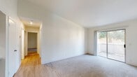 Located at 7413 S Land Park Dr in Sacramento's Land Park neighborhood, this 2-bedroom, 3-bathroom residence offers a practical and comfortable single-floor layout. The living area features a combination of plush carpeting and light hardwood-style flooring, with a sliding glass door that opens to an outdoor deck, filling the space with natural light and views of surrounding greenery.

The kitchen is equipped with warm wood cabinetry, a stainless steel refrigerator, and light hardwood-style flooring, with a ceiling fan overhead. It connects seamlessly to the main living area via a functional hallway.

Both bedrooms are carpeted and receive natural light through sliding glass doors or windows that frame views of mature trees. The primary bedroom includes mirrored sliding closet doors and direct access to a private outdoor deck. The second bedroom also features a closet and a bright window with tree views.

The three bathrooms are clean and functional, featuring white tub-shower combinations with curved chrome curtain rods, wood-toned vanity cabinetry, and light countertops. One bathroom is accessible directly from the primary bedroom area, offering added convenience.

Throughout the residence, neutral tones, white walls, and consistent finishes create a cohesive and calm ambiance.