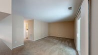 Located at 100 Hunt Club Trl in Marlton, NJ, this single-floor, 2-bedroom, 2-bathroom home offers a practical and comfortable layout. The living room is carpeted and spacious, featuring neutral beige walls and a sliding glass door that opens to an outdoor deck with tree-lined views, allowing ample natural light to fill the space. Adjacent to the living room is a dedicated dining area, also carpeted and brightened by a window with blinds and a ceiling light fixture.

The kitchen is well-appointed with rich wood cabinetry, granite-style countertops, wood-look flooring, and a full suite of appliances including an electric range, built-in microwave, dishwasher, and refrigerator. A dedicated in-unit laundry area houses a full-size washer and dryer with wire shelving above for added storage.

Both bedrooms are carpeted and feature neutral tones with windows that offer outdoor views. The primary bedroom is generously sized with ample room for furnishings. The two bathrooms include wood-look flooring, wood vanity cabinetry, and a tub-shower combination with tile surround. Throughout the home, five closets provide exceptional storage. Two hallways connect the rooms efficiently, rounding out this well-organized and functional floor plan.