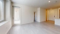 Located at 8901 Holly Ave NE in Albuquerque, NM, this modern 2-bedroom, 2-bathroom single-story home offers a thoughtfully designed open-concept layout with clean contemporary finishes throughout. Light-toned luxury vinyl plank flooring runs through the main living areas, complementing the bright, neutral color palette that gives the home an airy, welcoming ambiance.

The kitchen is a standout feature, showcasing two-tone cabinetry with light upper and warm wood-toned lower cabinets, quartz countertops, a large central island with a deep undermount sink and professional-style pull-down faucet, and a full suite of stainless steel appliances including a gas range, microwave, dishwasher, and French door refrigerator. Stylish pendant lighting accentuates the island, which flows seamlessly into the combined dining and living area. A patio door in the living room provides access to a private outdoor patio.

Both bedrooms are generously proportioned, filled with natural light through blinds-fitted windows, and equipped with ceiling fans. Each bedroom is served by its own closet. The primary bathroom features a dual-sink vanity with wood cabinetry and a glass-enclosed walk-in shower, while the second bathroom offers a soaking tub with tiled surround. A dedicated laundry area completes this well-appointed home.