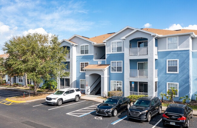 Front view of Village at Lake Pointe apartment building and resident parking. - Villages at Lake Pointe