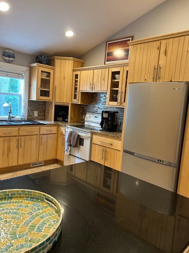 Kitchen with beautiful pine cabinets and solid surface countertops - 117 N 2nd St