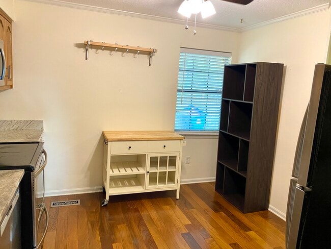 Lots of storage including island, pots and pans hanging shelf, and other shelves - 816 Oak St Townhome