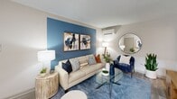 Located at 9015 Ten Mile Rd in Knoxville, TN, this one-bedroom, two-bathroom residence offers a thoughtfully designed single-floor layout that maximizes every square foot. The open-concept living and dining area features light wood-look flooring, a textured ceiling, and a bold blue accent wall that anchors the space with a modern, inviting feel. A wall-mounted mini-split unit provides efficient climate control, while the open sightlines create a sense of airiness throughout.

The kitchen is outfitted with rich dark-brown cabinetry, light stone-finish countertops, a stainless steel refrigerator, built-in microwave, and a full suite of appliances, including a dishwasher and electric range. Track lighting overhead enhances both function and style.

The bedroom offers a comfortable and private retreat, complete with plush carpet, a soothing blue accent wall, a dedicated closet with built-in shelving, and a wall-mounted mini-split for personalized comfort. Natural light filters in through a window dressed with patterned curtains.

Both bathrooms are clean and functional, with one featuring a shower-tub combination with tile surround and wood-look flooring. A dedicated closet rounds out the storage options in this efficiently laid-out Knoxville residence.