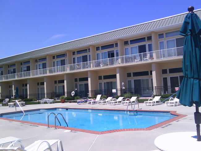 Complex view w large heated pool & chairs - 448 Ocean Ave