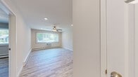 Located at 2720 McDivitt Rd in Madison, WI, this single-floor, three-bedroom, one-bathroom home offers a clean and functional layout with a bright, neutral aesthetic throughout. Light wood-look vinyl flooring runs continuously across the entire floor plan, creating a cohesive and easy-to-maintain living environment.

The kitchen is a standout feature, showcasing white shaker-style cabinetry extending to the ceiling, granite-look countertops, a stainless steel sink, and white appliances including a range, dishwasher, and refrigerator. Recessed lighting illuminates the space efficiently.

The combined kitchen and living area flows naturally, with the living room offering a large window dressed with vertical blinds, a wall-mounted AC unit, and baseboard heating — providing year-round climate control. A ceiling fan adds additional comfort.

Each of the three bedrooms features ceiling fans, baseboard heating, and windows that bring in natural light with views of the surrounding neighborhood. The primary bedroom includes a double sliding-door closet. The bedrooms maintain a clean, neutral palette with light gray walls and crisp white trim throughout.

The bathroom is finished with wood-look flooring, a white vanity with modern hardware, and a clean, minimalist design. Overall, the home presents a well-maintained, move-in-ready interior with consistent finishes throughout.