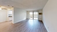 Located at 9090 Moody St in Cypress, California, this 2-bedroom, 3-bathroom residence offers a well-organized, single-floor layout designed for comfortable everyday living. The open living room is a welcoming centerpiece, featuring wood-style flooring, neutral white walls, a textured ceiling, and a sliding glass door that fills the space with natural light and provides direct access to a private outdoor patio. The kitchen is efficiently designed with white cabinetry, a gas range, a double-basin sink, ample counter space, and a window overlooking the exterior, creating a bright and functional cooking environment. Both bedrooms are carpeted and offer a calm, restful atmosphere. Each room is equipped with a ceiling fan and natural light from windows, while built-in sliding closets provide generous storage. The primary bedroom is notably spacious, offering plenty of room for a full furniture arrangement. Three bathrooms, each featuring tub-shower combinations and wood-style tile flooring, serve the home with practicality and clean, modern finishes. A dedicated closet and staircase access round out the interior. The overall aesthetic is clean and neutral throughout, making it a highly functional and move-in-ready home in the heart of Cypress.