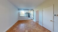 Located at 291 Avenue Rd in Toronto's prestigious Avenue Road corridor, this efficient single-floor unit makes smart use of its intimate footprint. The living room serves as the heart of the space, showcasing classic parquet wood flooring laid in a distinctive basket-weave pattern that adds warmth and character throughout. Large windows invite natural light and offer views of the surrounding greenery and building exteriors, with access to an outdoor balcony area that extends the sense of openness.

The kitchen is thoughtfully appointed with white cabinetry offering ample storage, dark granite-style countertops, a stainless steel sink, subway tile backsplash, and light ceramic tile flooring. A full-size Whirlpool refrigerator is included, completing a functional and tidy cooking space.

The bathroom features a classic retro aesthetic, highlighted by white hexagonal mosaic floor tiles accented with a small floral detail, white square wall tiles framed with dark border trim, and a vanity with granite countertop and medicine cabinet mirror. A built-in bathtub and bright overhead vanity lighting round out the well-maintained space.

A welcoming hallway connects all areas efficiently, contributing to the unit's practical and cohesive layout. This unit is ideally situated in one of Toronto's most sought-after midtown neighbourhoods.